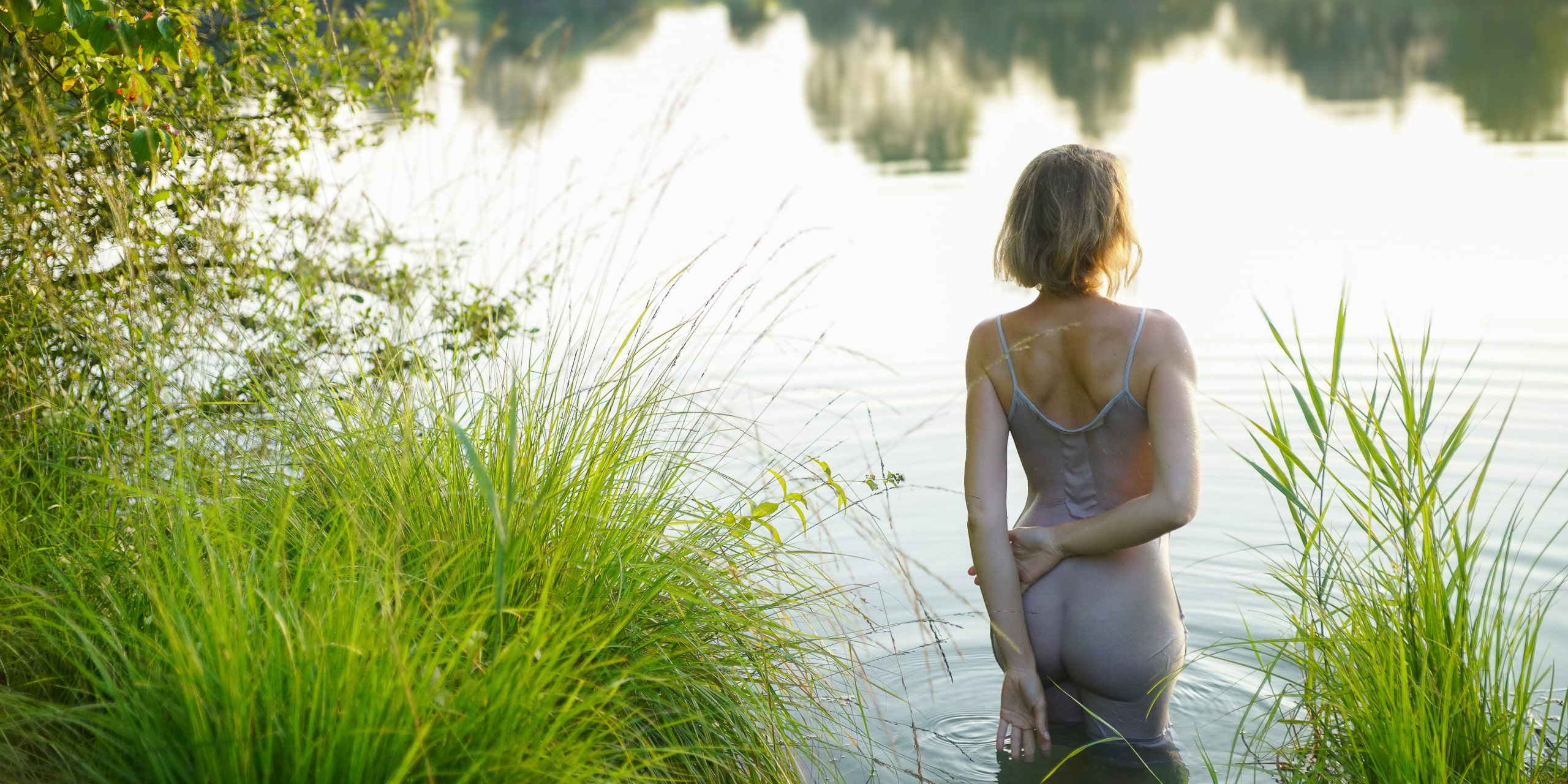 nude young woman at the lake